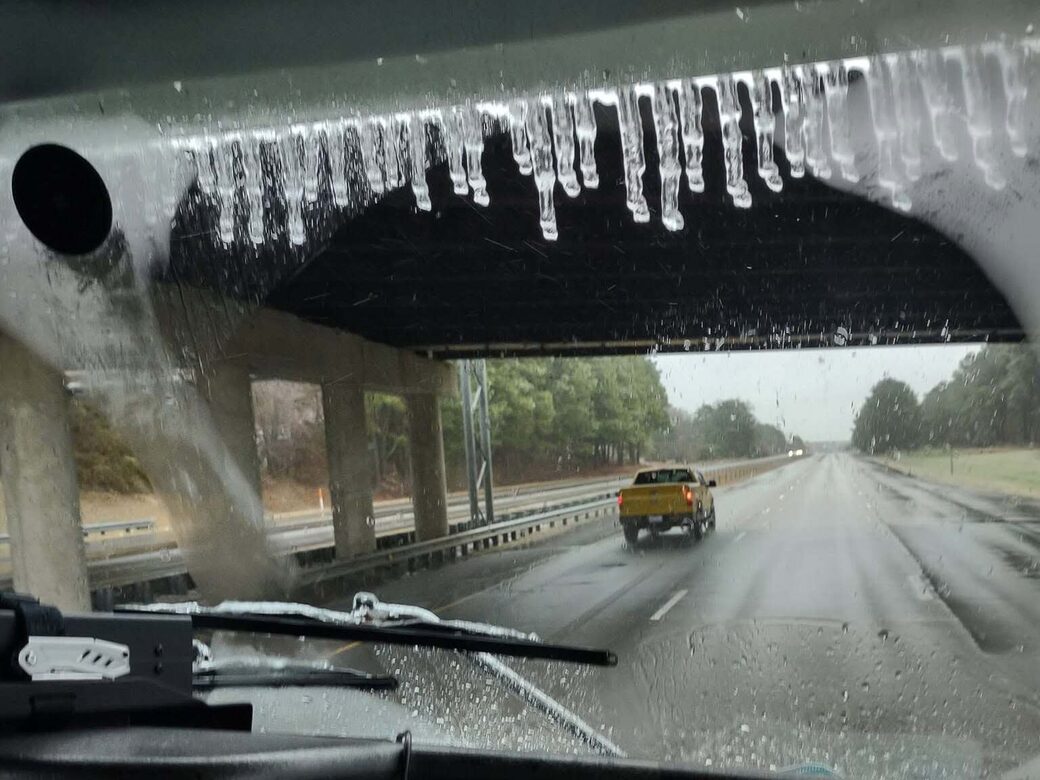 View from the cab of the DK Love Movers truck on a rain-swept North Carolina interstate during a long-distance move