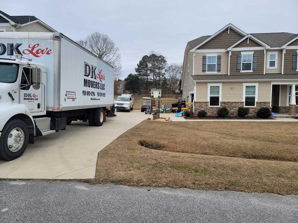 The DK Love Movers box truck backed into the driveway of a North Carolina home on moving day